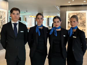 Four professionals providing high-level service at a financial event.