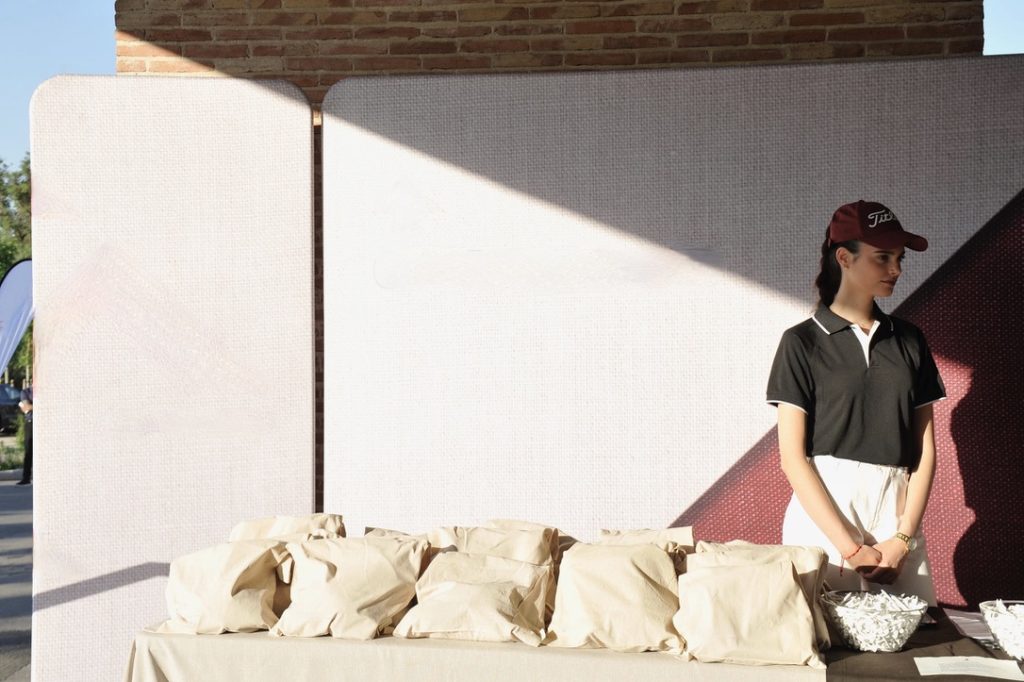 Hostess welcoming guests at a golf tournament.