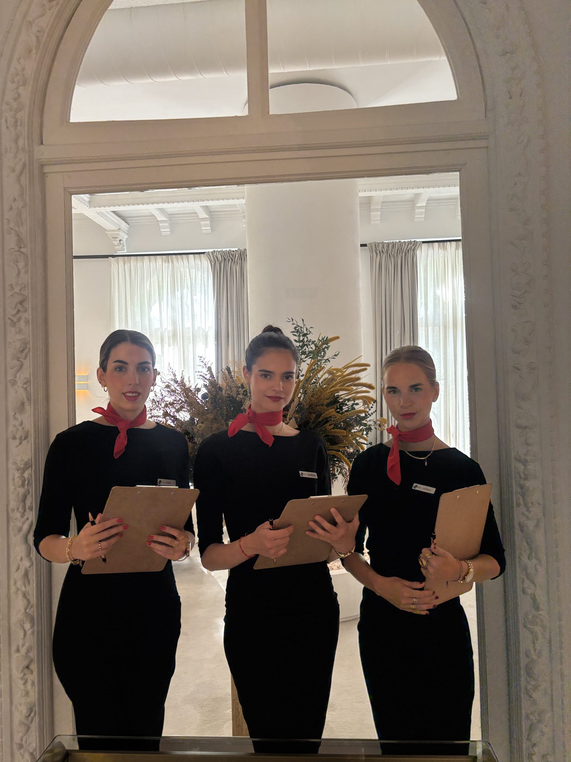 Azafatas sujetando carpetas de documentos